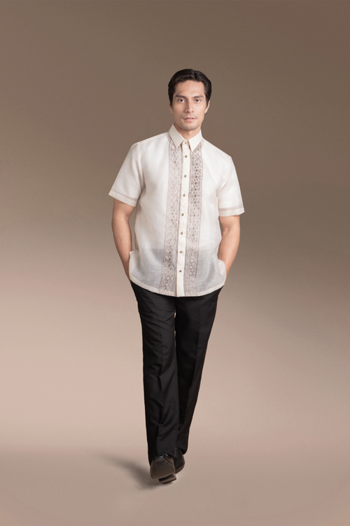 Man wearing an Onesimus Textured Faux Silk Barong Tagalog and black pants on a clean beige background