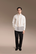 Man wearing a Onesimus Barong Tagalog with Classic Embroidered Detail with black pants on a brown plain background