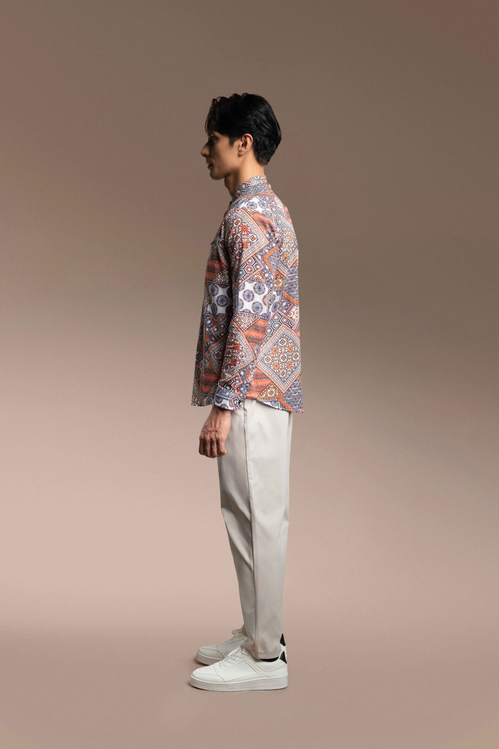 A man stands in Onésimus Men's Casual Shirts in Pure Cotton against a solid warm beige studio background.